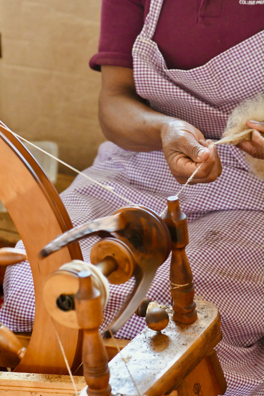 Close-up of an artisan spinning fibre by hand