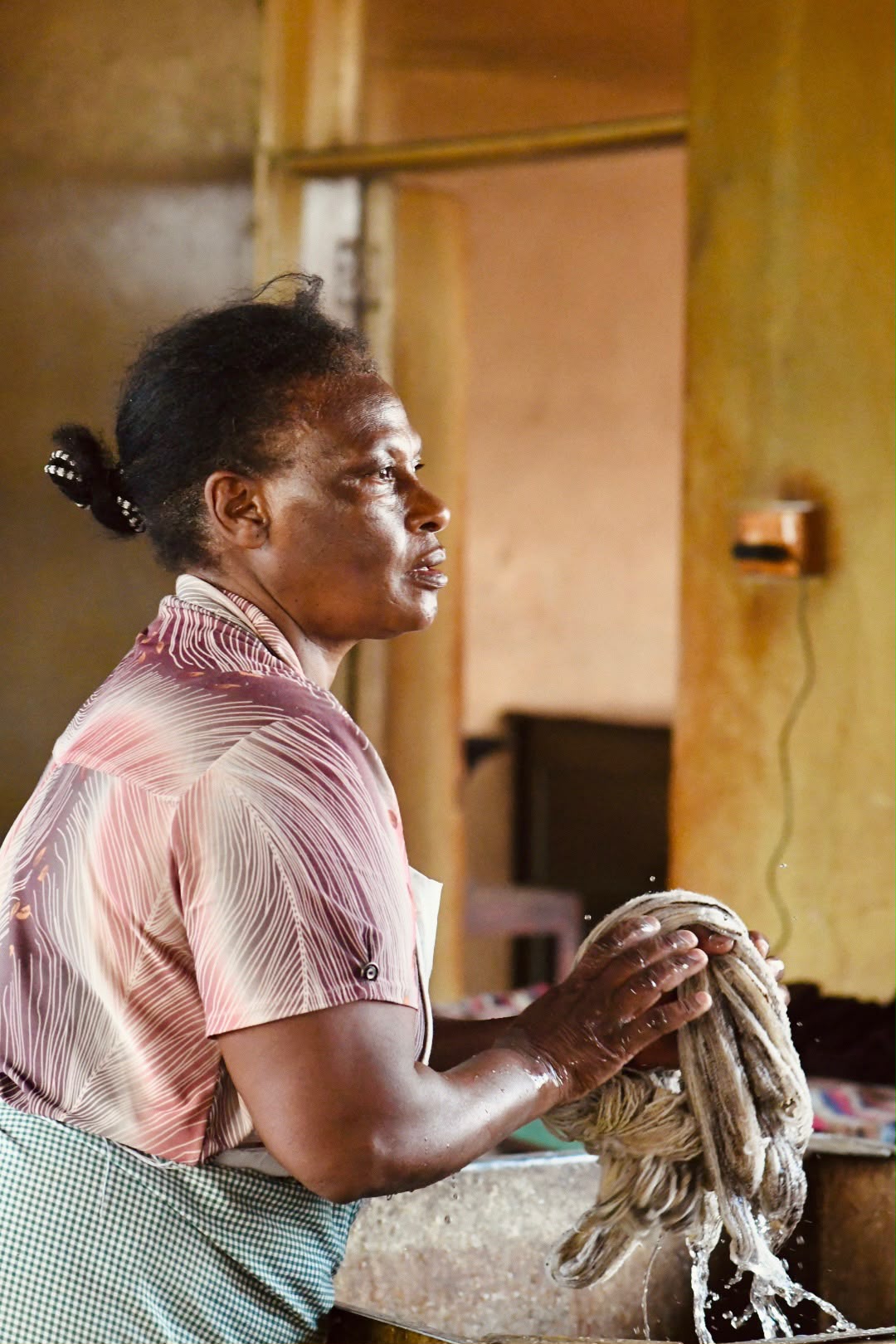 Artisan washing a bundle of yarn