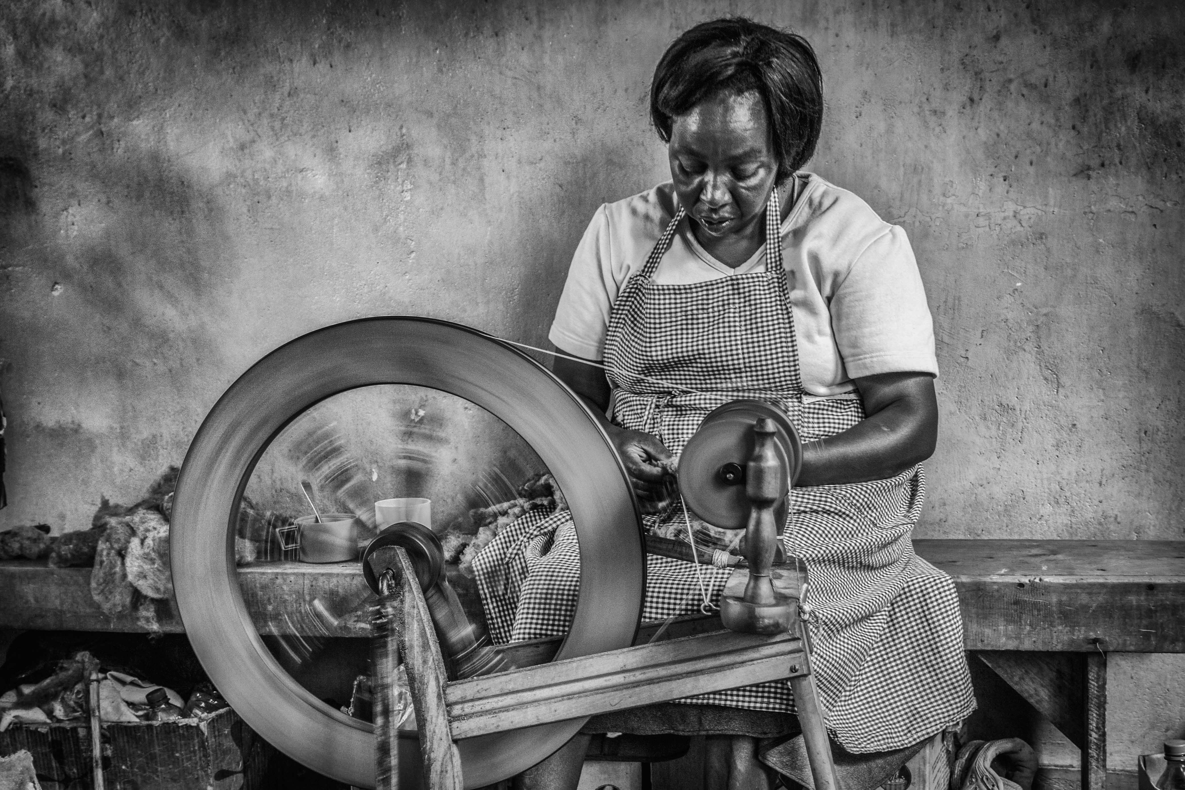 Smiling weaver holding colorful yarn